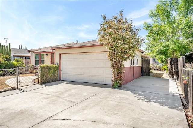 16230 Denley St, Hacienda Heights, CA 91745 - view of front of property with driveway, an attached garage, stucco siding, and fence