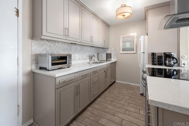 4007 Everts St Unit 4H, Pacific Beach San Diego, CA 92109 - kitchen with a toaster, range hood, a sink, backsplash, and gray cabinetry