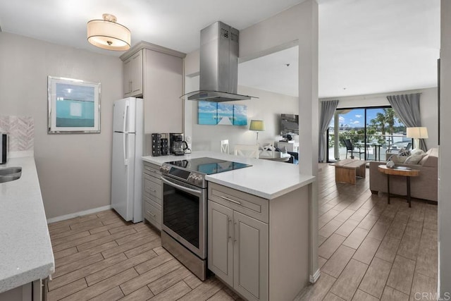 4007 Everts St Unit 4H, Pacific Beach San Diego, CA 92109 - kitchen featuring gray cabinets, range hood, light wood-type flooring, stainless steel range with electric stovetop, and freestanding refrigerator