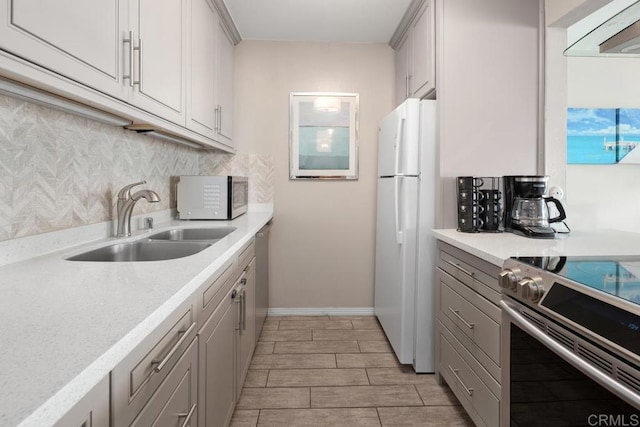 4007 Everts St Unit 4H, Pacific Beach San Diego, CA 92109 - kitchen featuring appliances with stainless steel finishes, a sink, extractor fan, gray cabinets, and backsplash