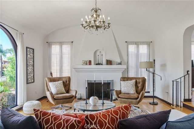 4368 Adams Ave, San Diego, CA 92116 - living room featuring arched walkways, wood finished floors, healthy amount of natural light, a chandelier, and lofted ceiling