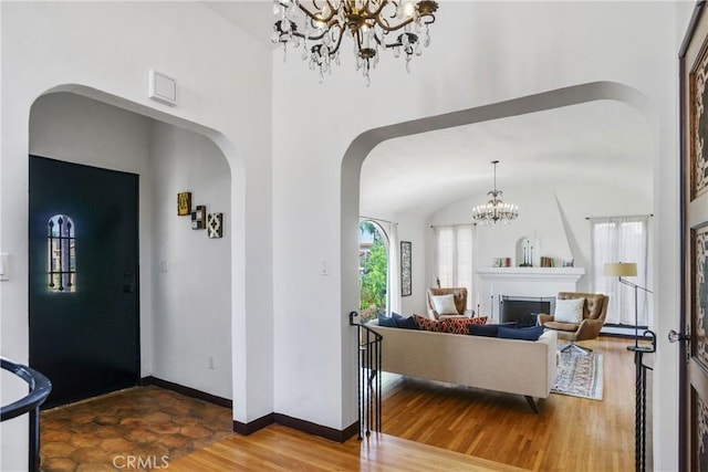 4368 Adams Ave, San Diego, CA 92116 - entrance foyer featuring arched walkways, a chandelier, and wood finished floors