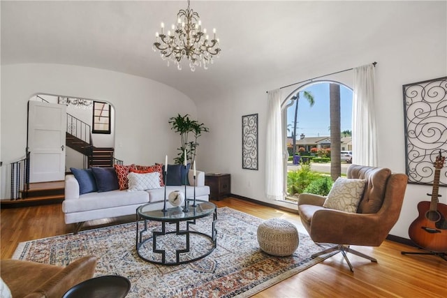 4368 Adams Ave, San Diego, CA 92116 - living area with stairs, healthy amount of natural light, a chandelier, wood finished floors, and vaulted ceiling