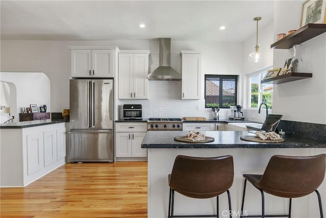 4368 Adams Ave, San Diego, CA 92116 - kitchen with high end fridge, wall chimney range hood, a peninsula, open shelves, and dark countertops