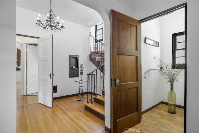 4368 Adams Ave, San Diego, CA 92116 - foyer entrance featuring stairs, wood finished floors, arched walkways, and healthy amount of natural light