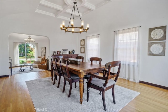 4368 Adams Ave, San Diego, CA 92116 - dining area featuring a chandelier, coffered ceiling, light wood finished floors, arched walkways, and beam ceiling