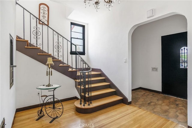 4368 Adams Ave, San Diego, CA 92116 - foyer entrance featuring arched walkways, wood finished floors, healthy amount of natural light, and stairway