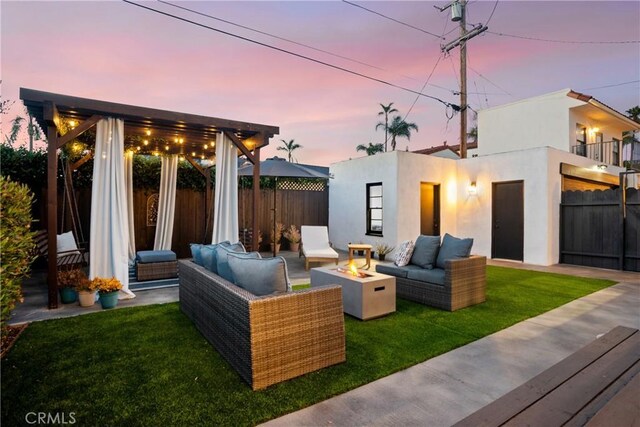 4368 Adams Ave, San Diego, CA 92116 - patio terrace at dusk featuring an outdoor living space with a fire pit, a fenced backyard, a balcony, and a patio area