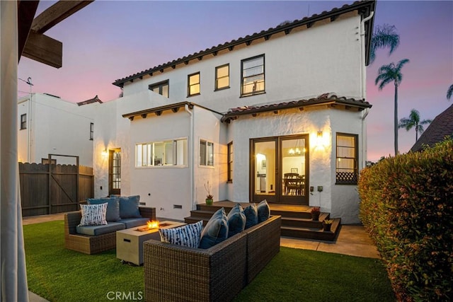 4368 Adams Ave, San Diego, CA 92116 - back of property at dusk featuring an outdoor living space with a fire pit and stucco siding