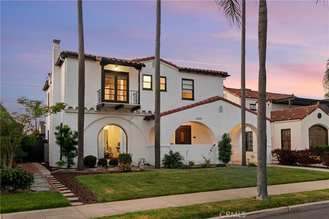 4368 Adams Ave, San Diego, CA 92116 - mediterranean / spanish house featuring a balcony, stucco siding, a lawn, a tiled roof, and a chimney