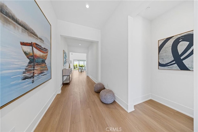 corridor with recessed lighting, light wood finished floors, and baseboards