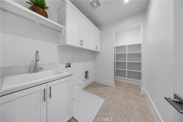 laundry room with a sink, hookup for an electric dryer, baseboards, hookup for a washing machine, and cabinet space