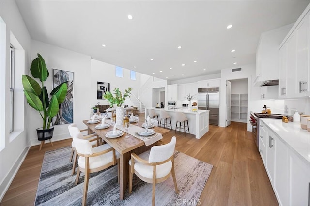 dining room with recessed lighting, light wood-style floors, visible vents, and baseboards