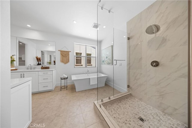bathroom with recessed lighting, visible vents, vanity, a freestanding tub, and tiled shower