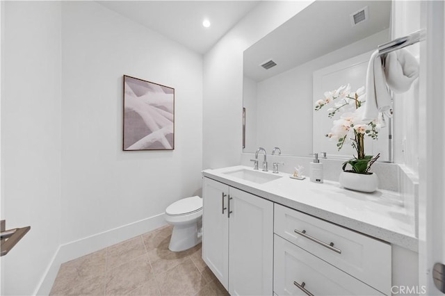 bathroom featuring baseboards, visible vents, vanity, and toilet