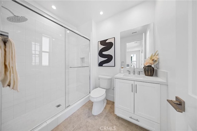 bathroom with recessed lighting, a shower stall, tile patterned floors, toilet, and vanity