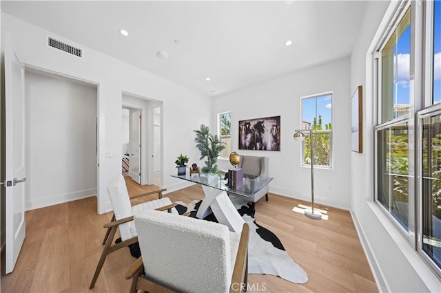 home office with recessed lighting, light wood-type flooring, visible vents, and baseboards