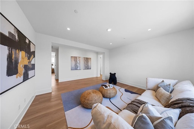 living area featuring recessed lighting, wood finished floors, and baseboards