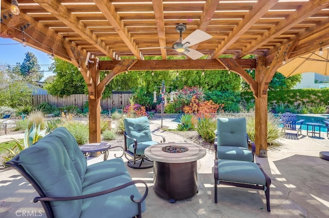 view of patio / terrace featuring ceiling fan, fence, a fire pit, and a pergola