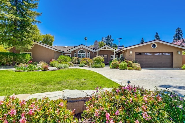 6217 Melba Ave, Woodland Hills, CA 91367 - ranch-style house featuring stucco siding, an attached garage, a front lawn, and concrete driveway