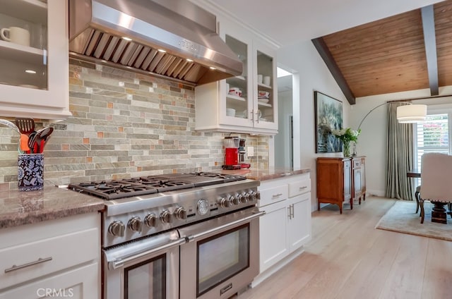 6217 Melba Ave, Woodland Hills, CA 91367 - kitchen with range with two ovens, wall chimney exhaust hood, tasteful backsplash, vaulted ceiling, and light stone counters