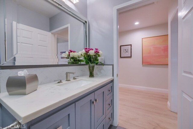 6217 Melba Ave, Woodland Hills, CA 91367 - bathroom featuring tasteful backsplash, vanity, wood finished floors, recessed lighting, and baseboards