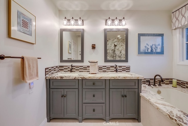 bathroom with tasteful backsplash, a garden tub, a sink, and double vanity
