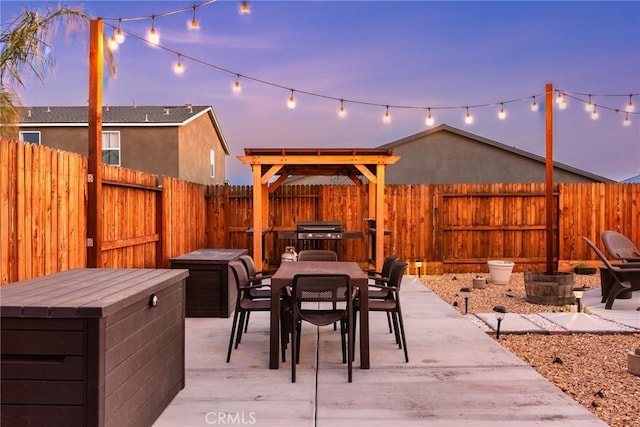 view of patio with outdoor dining area, a fenced backyard, and a grill