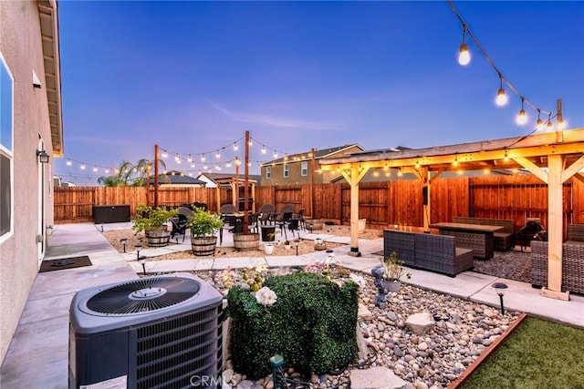 view of patio with an outdoor living space with a fire pit, a fenced backyard, and central AC