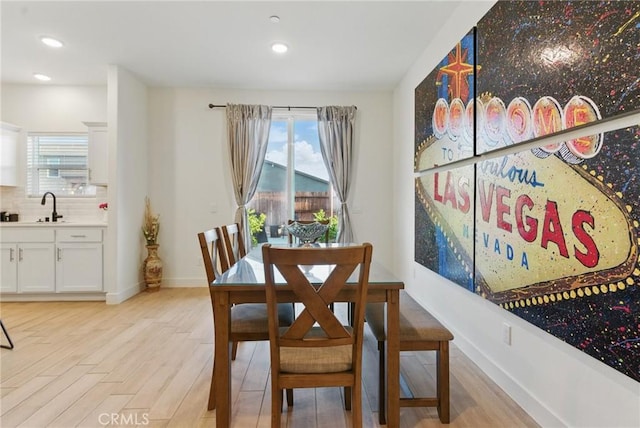 dining space with recessed lighting, plenty of natural light, and light wood finished floors