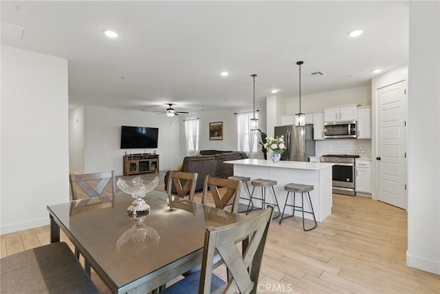 dining space featuring visible vents, ceiling fan, light wood finished floors, and recessed lighting