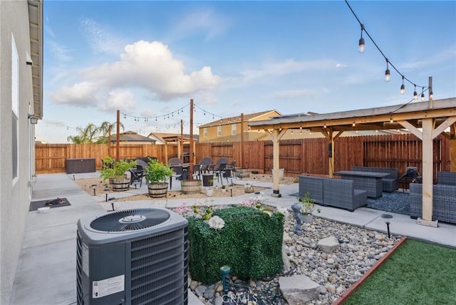 view of patio / terrace featuring cooling unit, an outdoor living space with a fire pit, and a fenced backyard