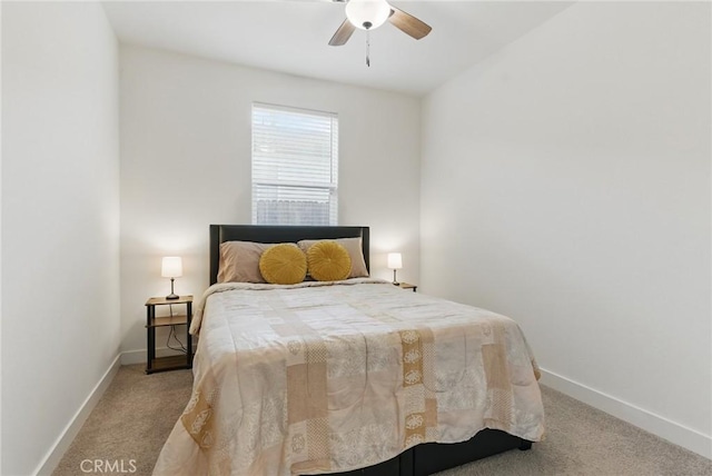 carpeted bedroom featuring baseboards and a ceiling fan