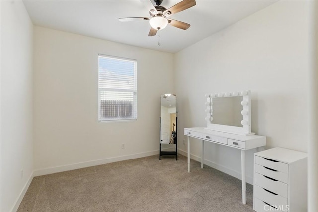 bedroom with light colored carpet, baseboards, and a ceiling fan