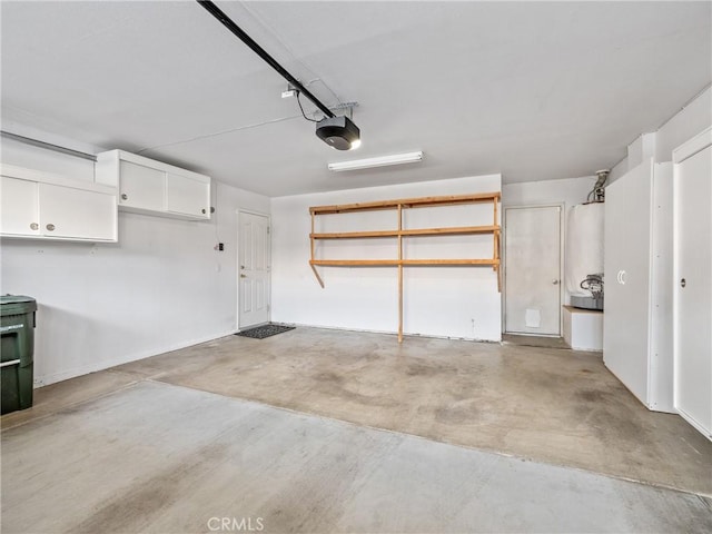 garage with water heater and a garage door opener