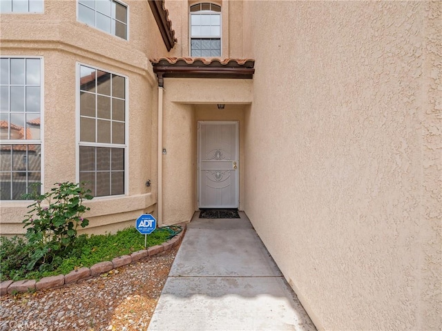 doorway to property with stucco siding