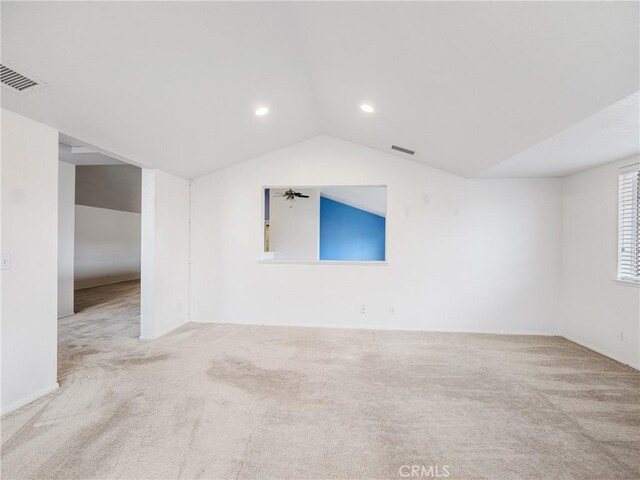 unfurnished room with carpet floors, lofted ceiling, visible vents, and recessed lighting