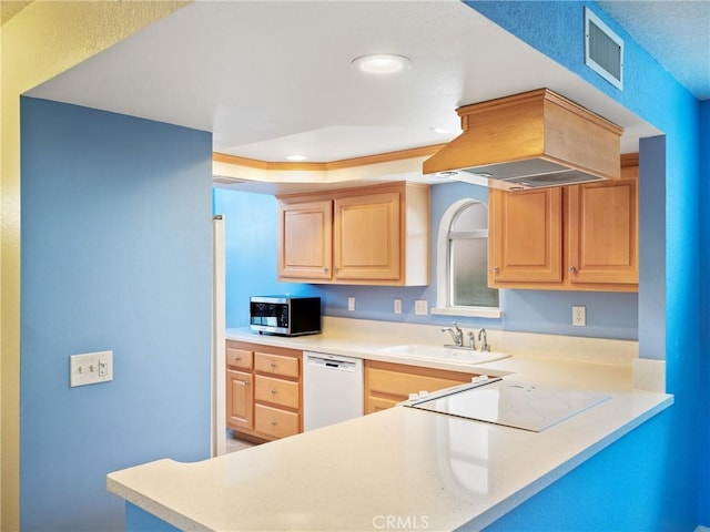 kitchen featuring light brown cabinets, a sink, white appliances, light countertops, and visible vents