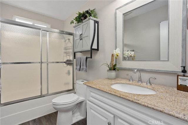 31725 Rancho Amigos Rd, Bonsall, CA 92003 - full bath with toilet, wood finished floors, bath / shower combo with glass door, and vanity