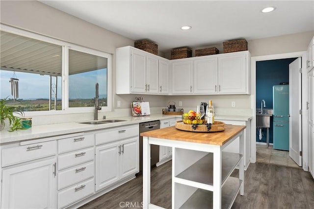 31725 Rancho Amigos Rd, Bonsall, CA 92003 - kitchen featuring a sink, wood counters, dark wood finished floors, white cabinetry, and dishwashing machine