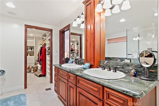2408 Ocean Dr, Oxnard, CA 93035 - bathroom with double vanity, a sink, tile patterned flooring, and a walk in closet