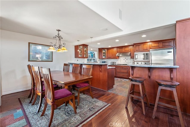 2408 Ocean Dr, Oxnard, CA 93035 - dining room with dark wood-style flooring, baseboards, recessed lighting, and a chandelier