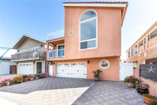 2408 Ocean Dr, Oxnard, CA 93035 - multi unit property featuring stucco siding, decorative driveway, fence, a gate, and a garage