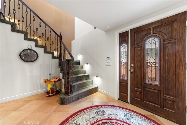 2408 Ocean Dr, Oxnard, CA 93035 - entrance foyer with tile patterned floors, baseboards, and stairway
