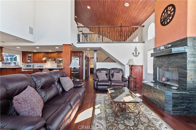 2408 Ocean Dr, Oxnard, CA 93035 - living room with wood ceiling, dark wood-style flooring, a towering ceiling, and a fireplace