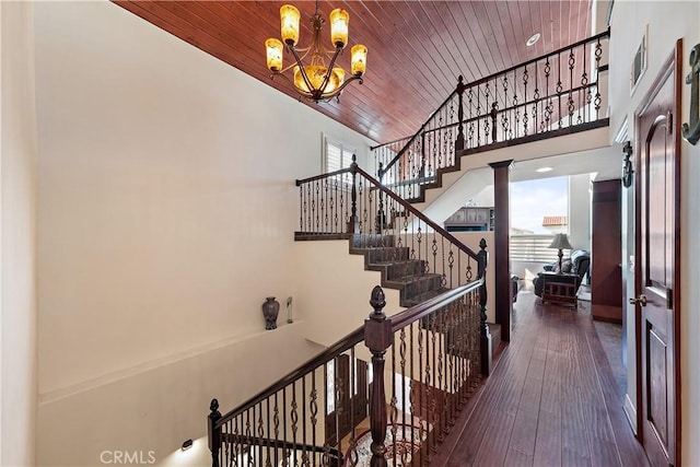 2408 Ocean Dr, Oxnard, CA 93035 - stairs featuring a notable chandelier, visible vents, high vaulted ceiling, wood-type flooring, and wooden ceiling
