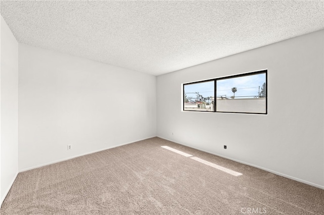 1144 N Lyman Ave, Covina, CA 91724 - empty room featuring a textured ceiling, baseboards, and carpet