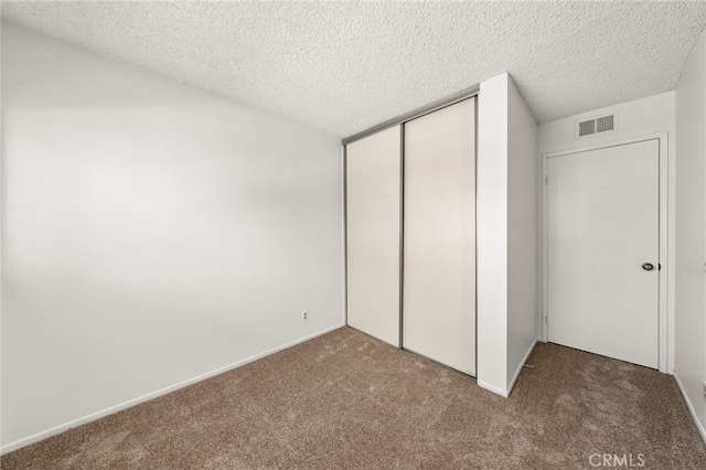 1144 N Lyman Ave, Covina, CA 91724 - unfurnished bedroom with a closet, carpet, visible vents, and a textured ceiling