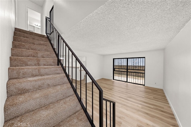 1144 N Lyman Ave, Covina, CA 91724 - stairs with baseboards and wood finished floors