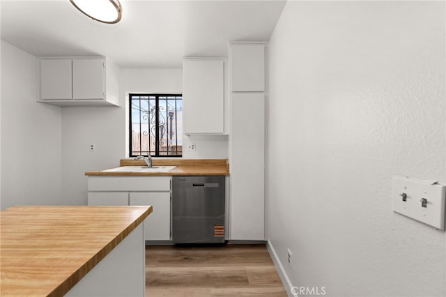 1144 N Lyman Ave, Covina, CA 91724 - kitchen featuring stainless steel dishwasher, light wood-type flooring, white cabinetry, a sink, and baseboards